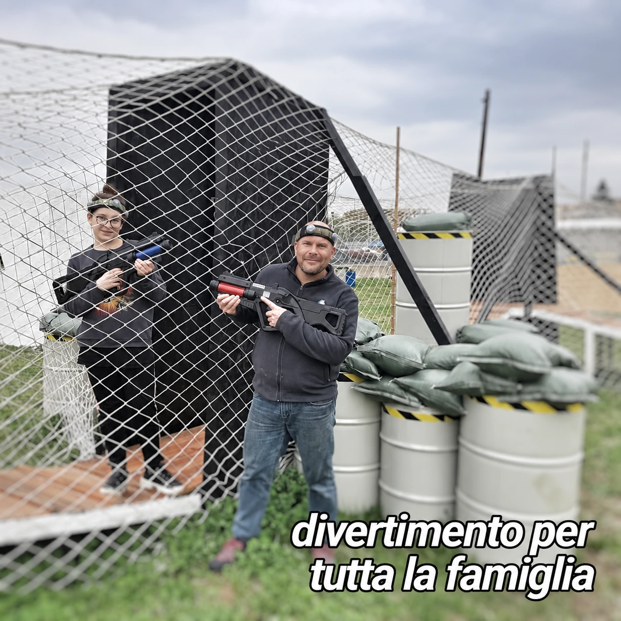 Due giocatori con dispositivi Laser Tag e sensori sulla fronte nel campo all’aperto